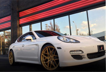 White sports car with gold alloy wheel paint
