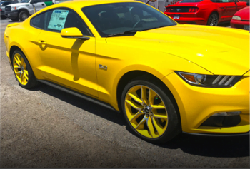 Custom alloy wheel and rim paint in yellow to match a Mustang