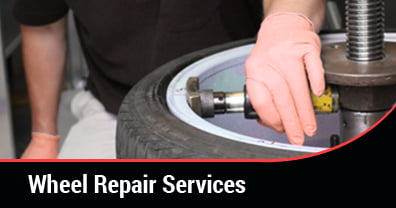 A technician performing an alloy wheel repair service