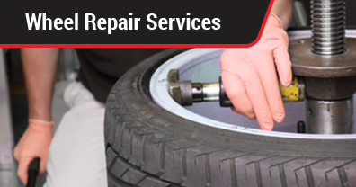 A technician performing an alloy wheel repair service