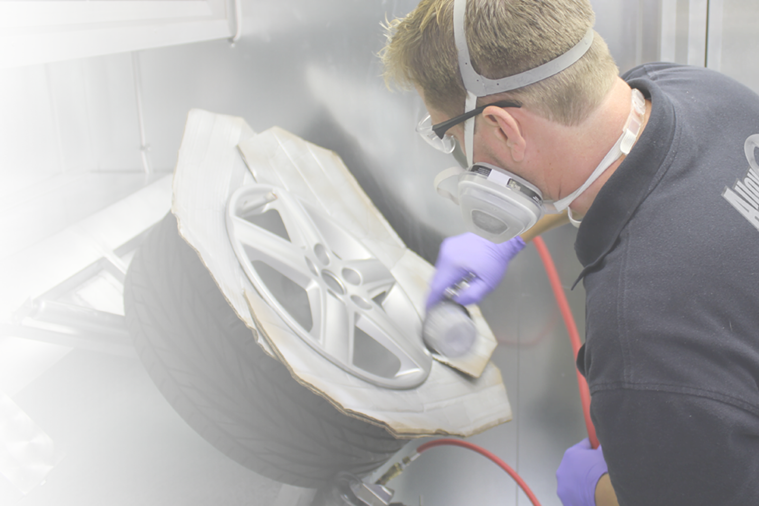 Technician applying wheel paint